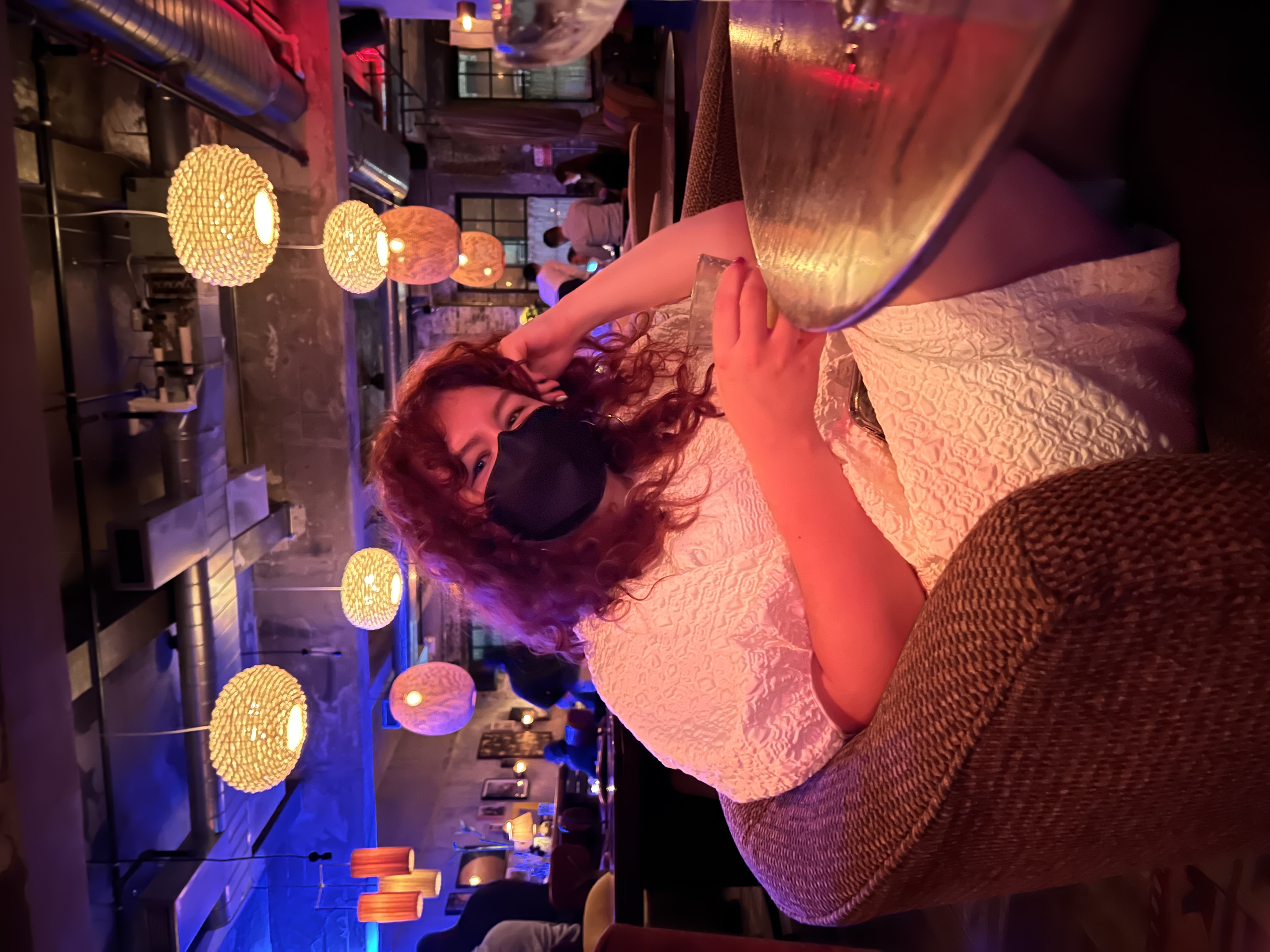 Author Dani Pierson wearing a mask sitting at a restaurant